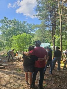 1000054235 Mission team serving together in the woods